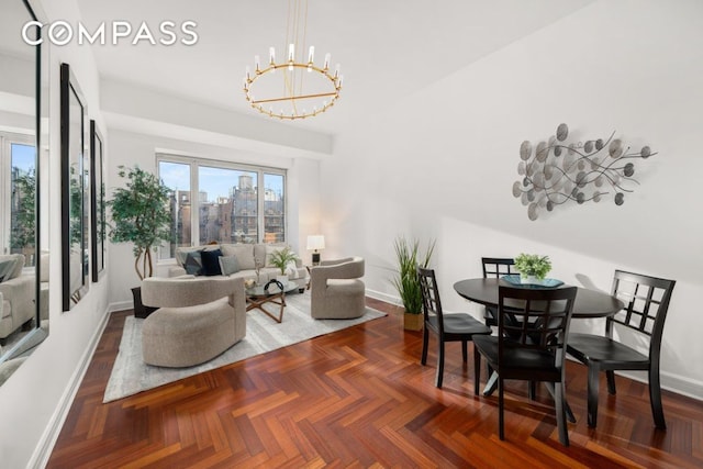 living room with dark parquet flooring and a notable chandelier