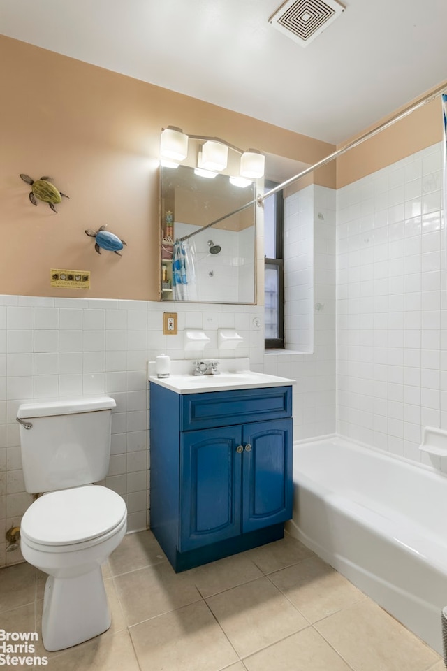 full bathroom with tile patterned floors, vanity, tile walls, toilet, and visible vents
