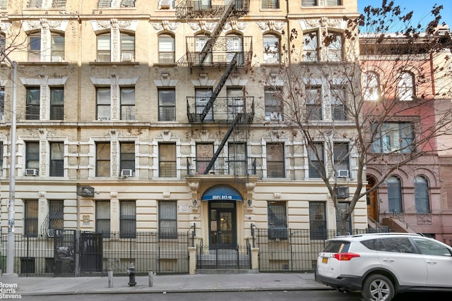 view of building exterior with fence