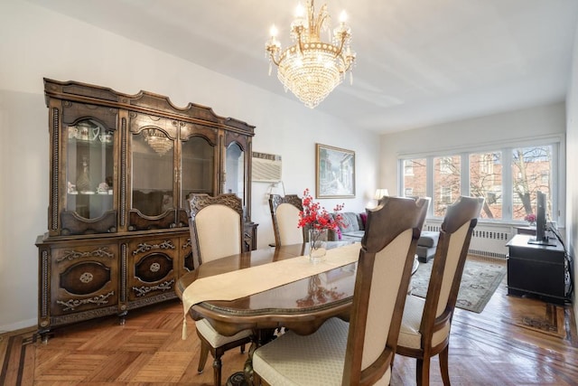 dining area with parquet floors, a wall mounted AC, radiator, and a chandelier