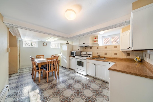 kitchen featuring sink, white appliances, and white cabinets