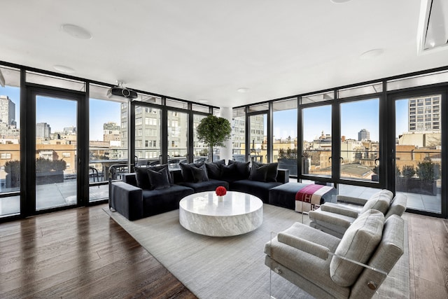 living room with floor to ceiling windows and hardwood / wood-style floors