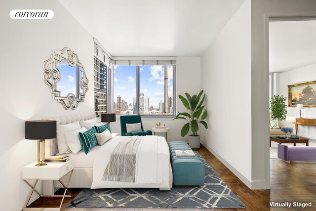 bedroom featuring visible vents, a view of city, and baseboards