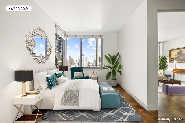 bedroom with visible vents, parquet flooring, a city view, and baseboards