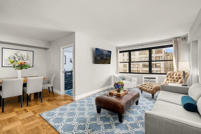 living room featuring light parquet floors and a wall mounted AC