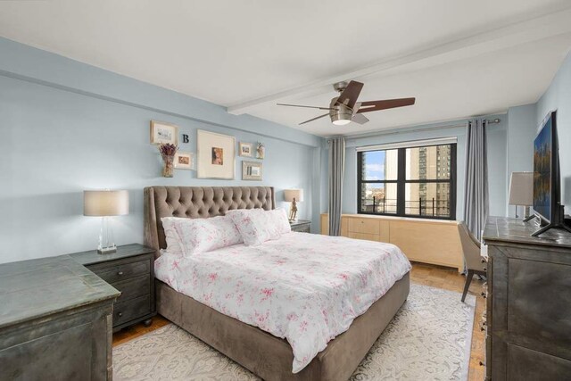 bedroom featuring beamed ceiling and ceiling fan