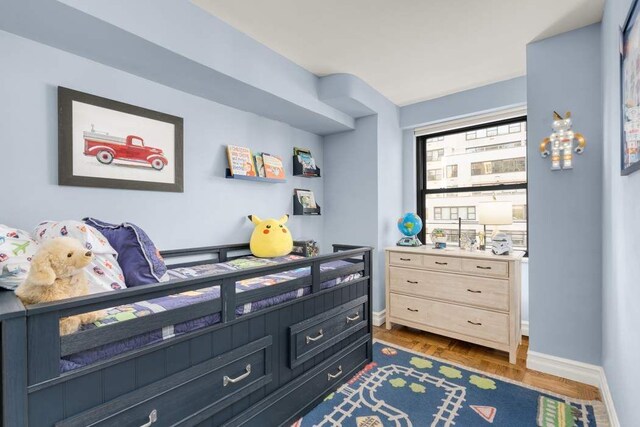 bedroom with dark parquet floors