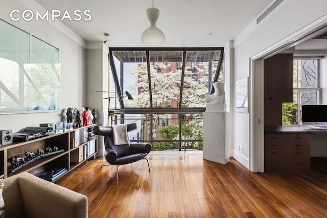 living area featuring floor to ceiling windows and wood finished floors