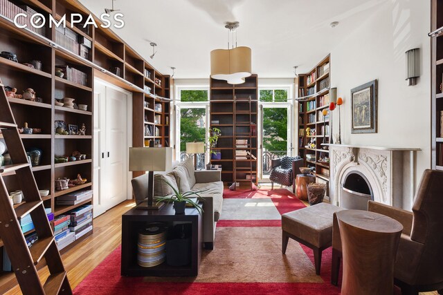 sitting room with a skylight and light wood-type flooring