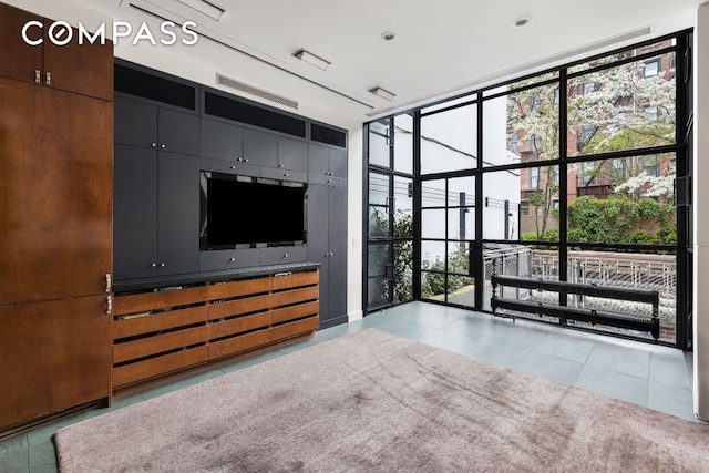 interior space featuring expansive windows and light tile patterned flooring