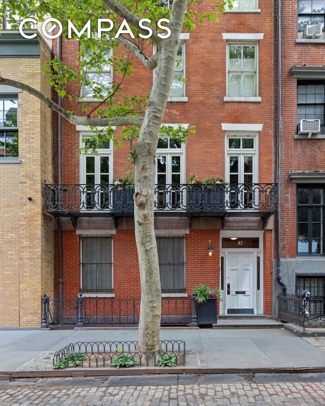 exterior space featuring cooling unit and brick siding