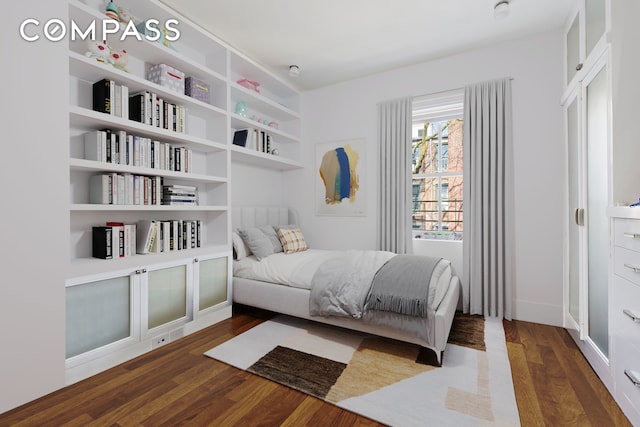 bedroom featuring dark wood finished floors