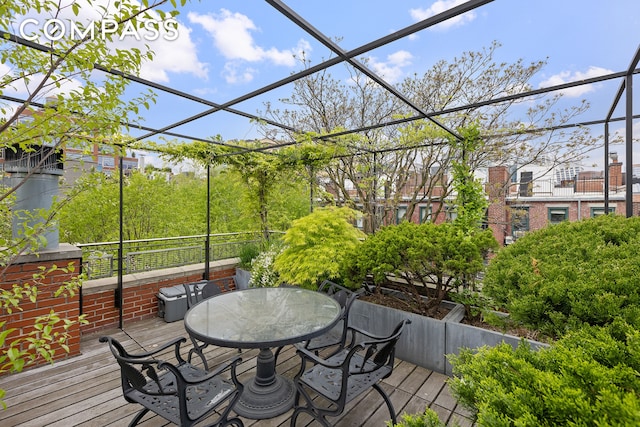 exterior space featuring a lanai, outdoor dining space, and a deck