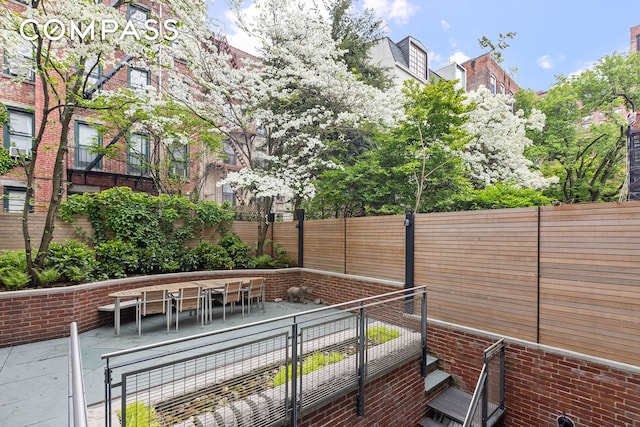 view of patio with outdoor dining area and fence private yard