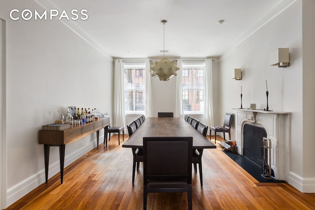 dining space featuring an inviting chandelier, baseboards, and hardwood / wood-style floors