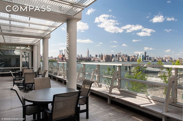 exterior space with a view of city, outdoor dining area, and a pergola