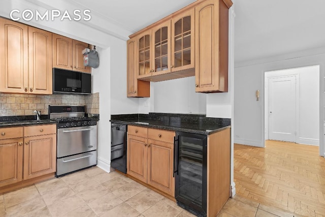 kitchen featuring beverage cooler, decorative backsplash, light parquet floors, dark stone counters, and black appliances