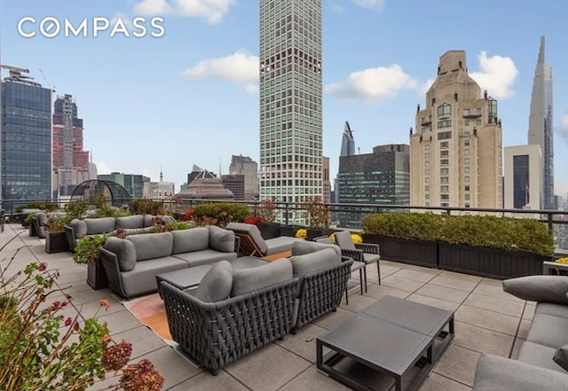 view of patio / terrace featuring a view of city and an outdoor hangout area