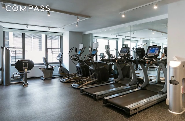 exercise room featuring rail lighting