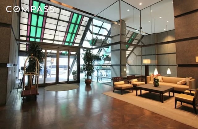 117 E 57th St Unit 35D, New York City, NY 10022 - community lobby featuring a high ceiling and expansive windows