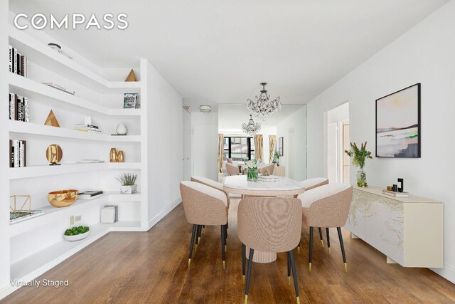 dining space featuring wood-type flooring, built in features, and a notable chandelier