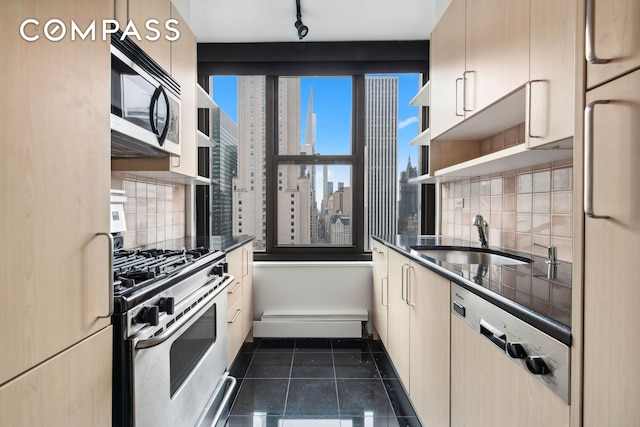 kitchen with dark countertops, stainless steel range with gas cooktop, open shelves, and a sink