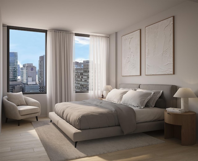 bedroom featuring light wood-style floors and a city view