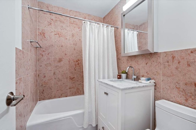 full bathroom featuring vanity, tile walls, shower / tub combo, and toilet