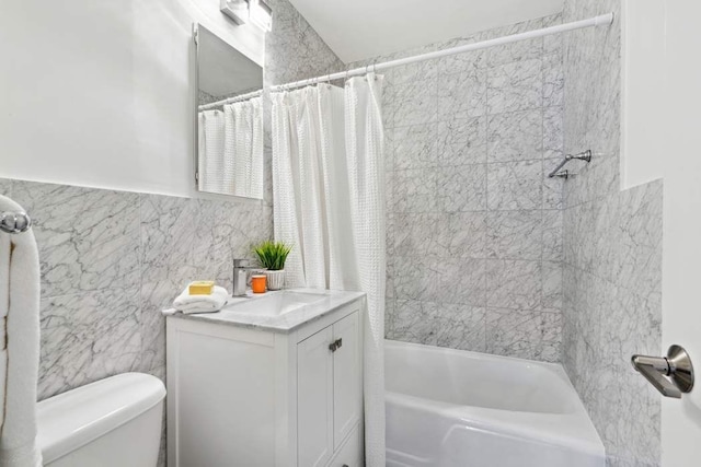 full bathroom featuring vanity, tile walls, shower / bath combination with curtain, and toilet