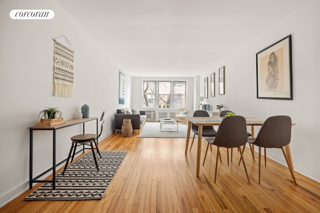 dining area featuring visible vents, baseboards, and hardwood / wood-style flooring