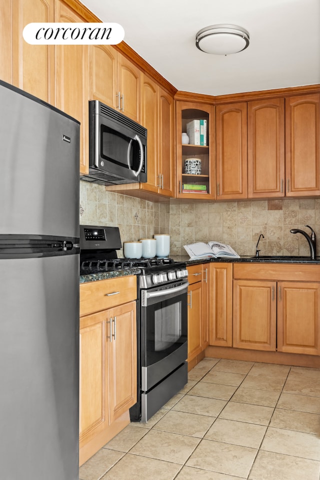 415 Argyle Rd Unit 5U, New York City, NY 11218 - kitchen with stainless steel appliances, dark stone counters, tasteful backsplash, and a sink