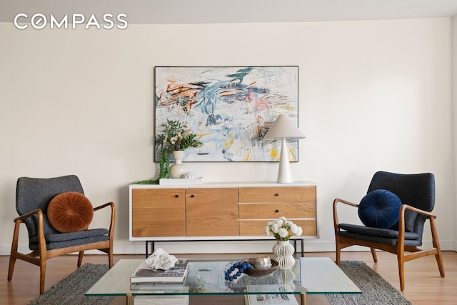 sitting room with light wood-type flooring and baseboards