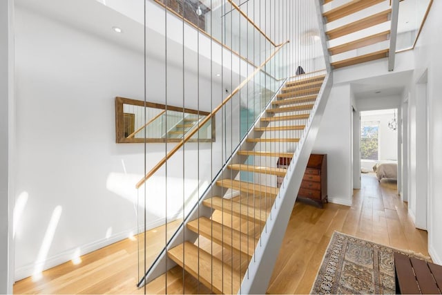 staircase featuring wood-type flooring