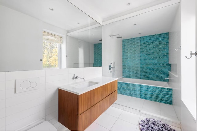 bathroom featuring vanity, tile patterned flooring, and tile walls