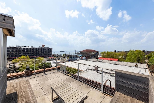 view of patio / terrace with a water view and a balcony