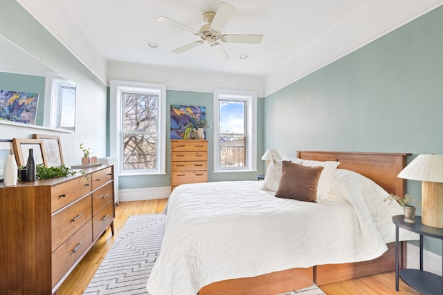 bedroom with light hardwood / wood-style flooring and ceiling fan