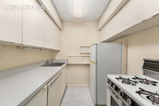 kitchen featuring white cabinetry, sink, and white appliances