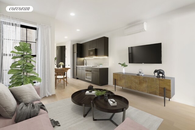 living room featuring light hardwood / wood-style flooring and an AC wall unit