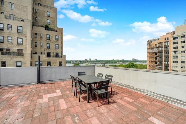 view of patio / terrace featuring a view of city and outdoor dining area