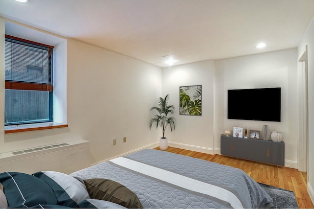 bedroom with recessed lighting, baseboards, and wood finished floors