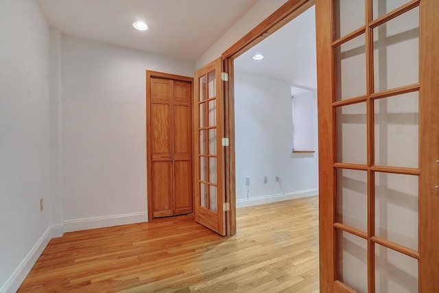 unfurnished room featuring recessed lighting, french doors, baseboards, and light wood finished floors