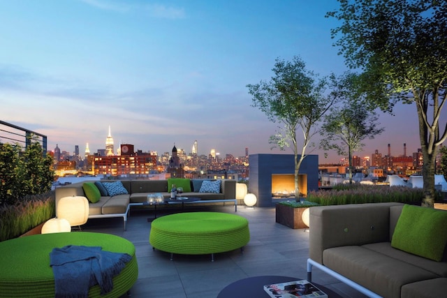 150 Rivington St Unit 5F, New York City, NY 10002 - patio terrace at dusk with an outdoor living space with a fireplace, a skyline view, and a patio area