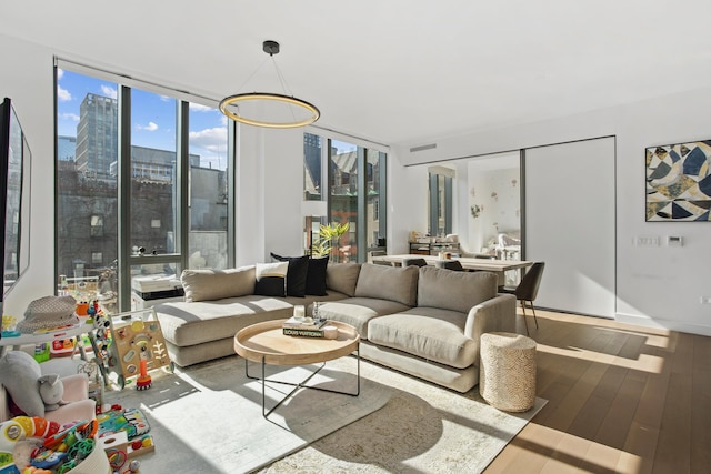 living area featuring floor to ceiling windows and wood finished floors