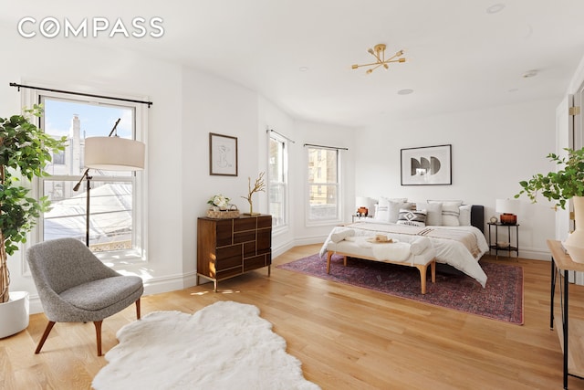 bedroom featuring baseboards and light wood-style flooring