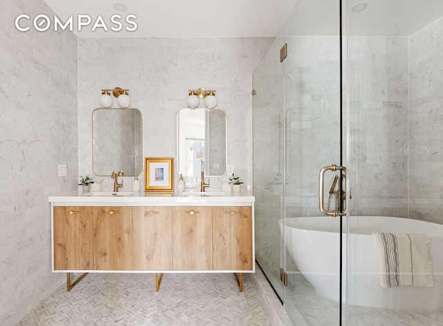 full bath featuring double vanity, a freestanding tub, and a sink