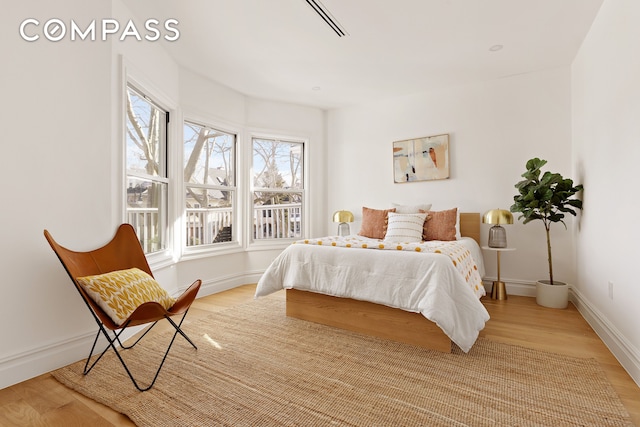 bedroom with baseboards and light wood-type flooring