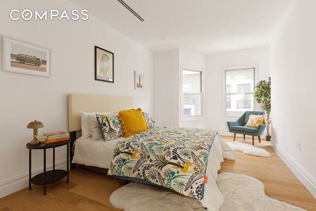 bedroom featuring baseboards and wood finished floors