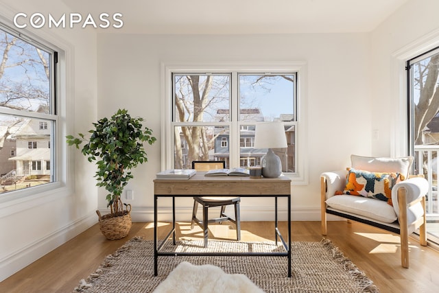 office space with baseboards and wood finished floors