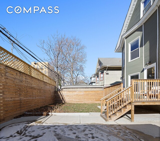 exterior space featuring a wooden deck and a fenced backyard