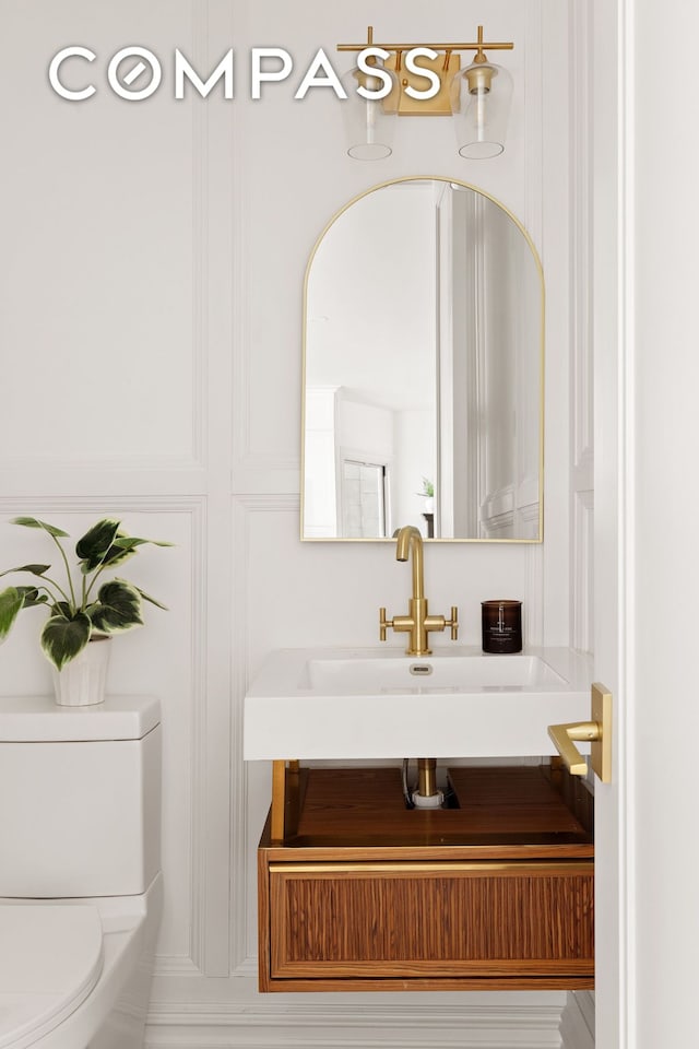 bathroom featuring vanity and toilet